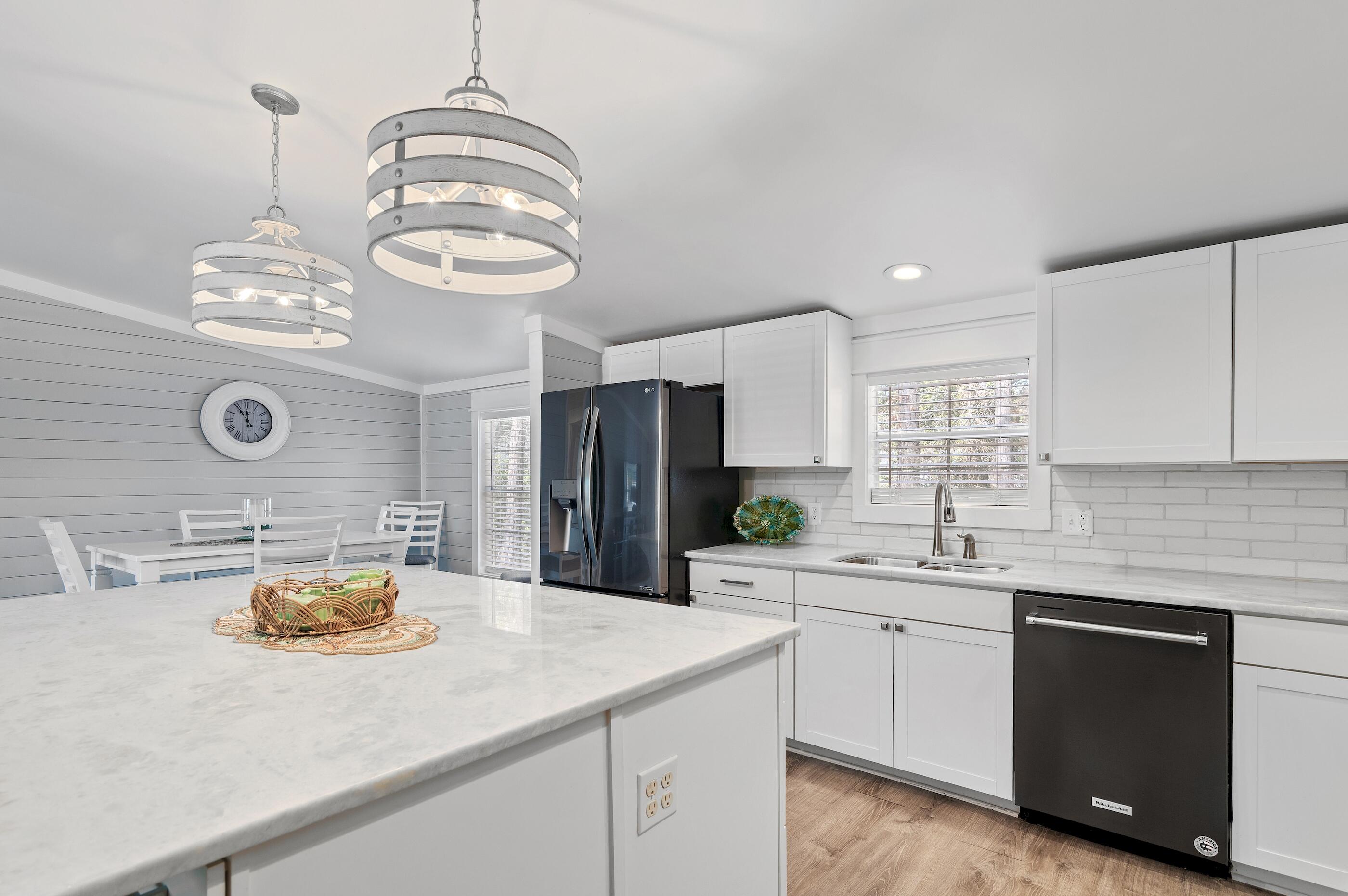 301 Edgewood Terrace Santa Rosa Beach, FL 32459 - Photo 12 of 34 a kitchen with stainless steel appliances a sink a microwave a stove and cabinets
