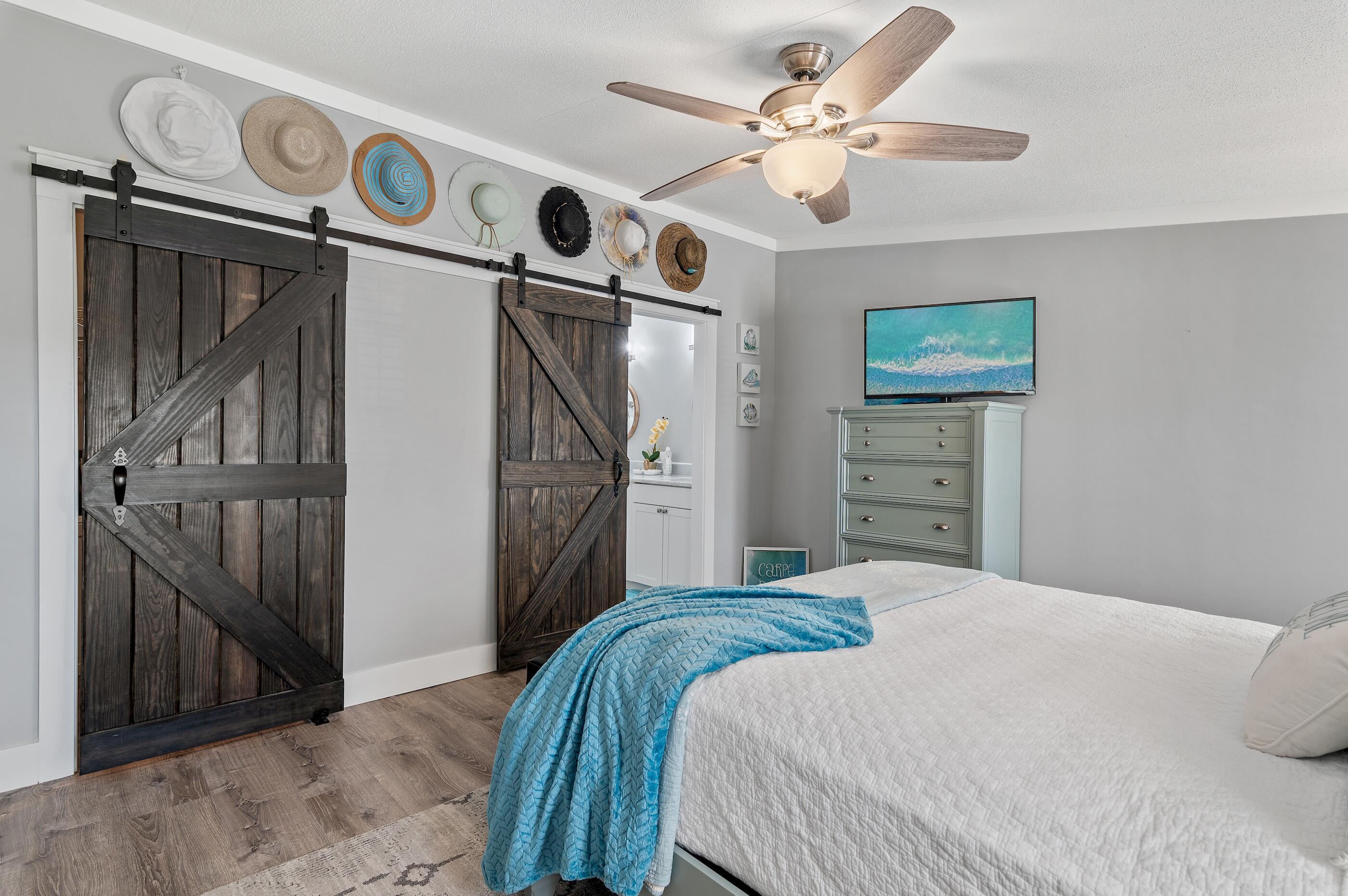 301 Edgewood Terrace Santa Rosa Beach, FL 32459 - Photo 19 of 34 a bedroom with a bed and a chandelier