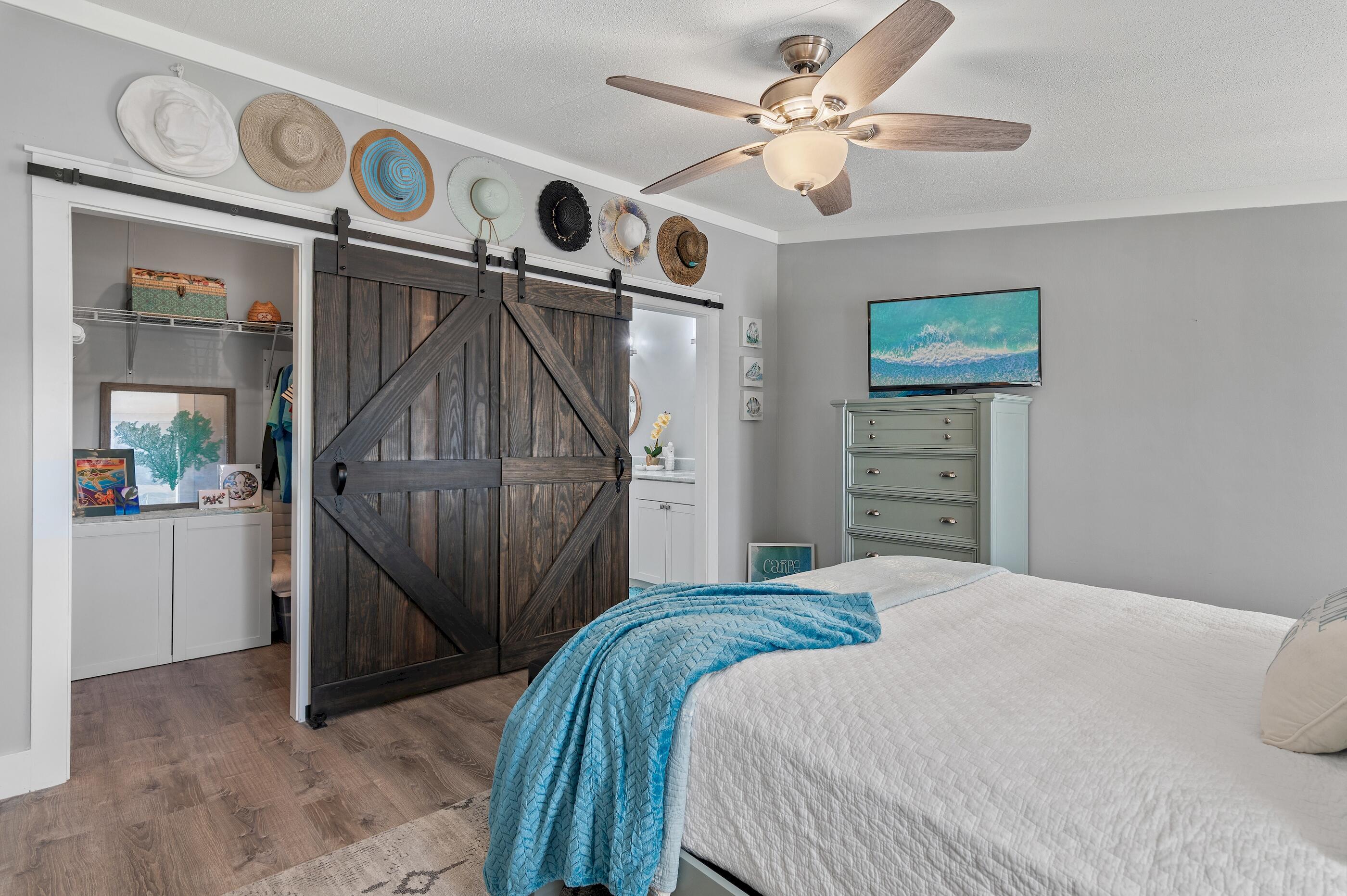 301 Edgewood Terrace Santa Rosa Beach, FL 32459 - Photo 2 of 34 a bedroom with a bed and a chandelier