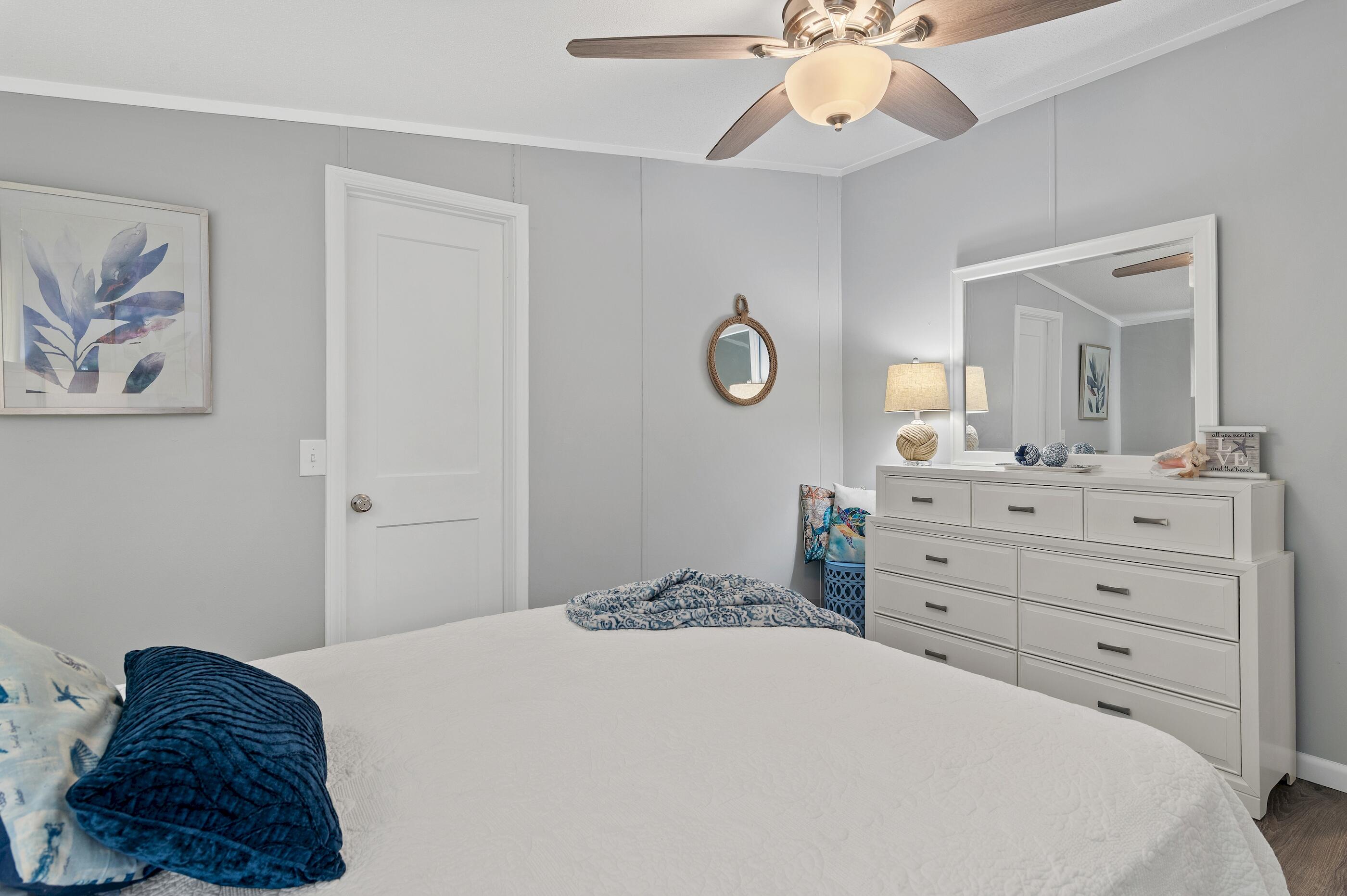 301 Edgewood Terrace Santa Rosa Beach, FL 32459 - Photo 22 of 34 a bedroom with a bed and a chandelier