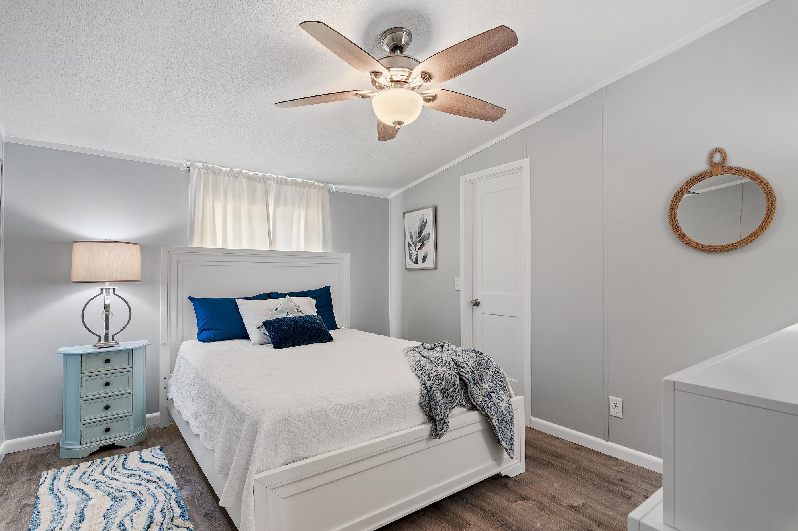 301 Edgewood Terrace Santa Rosa Beach, FL 32459 - Photo 23 of 34 a bedroom with a bed and a lamp