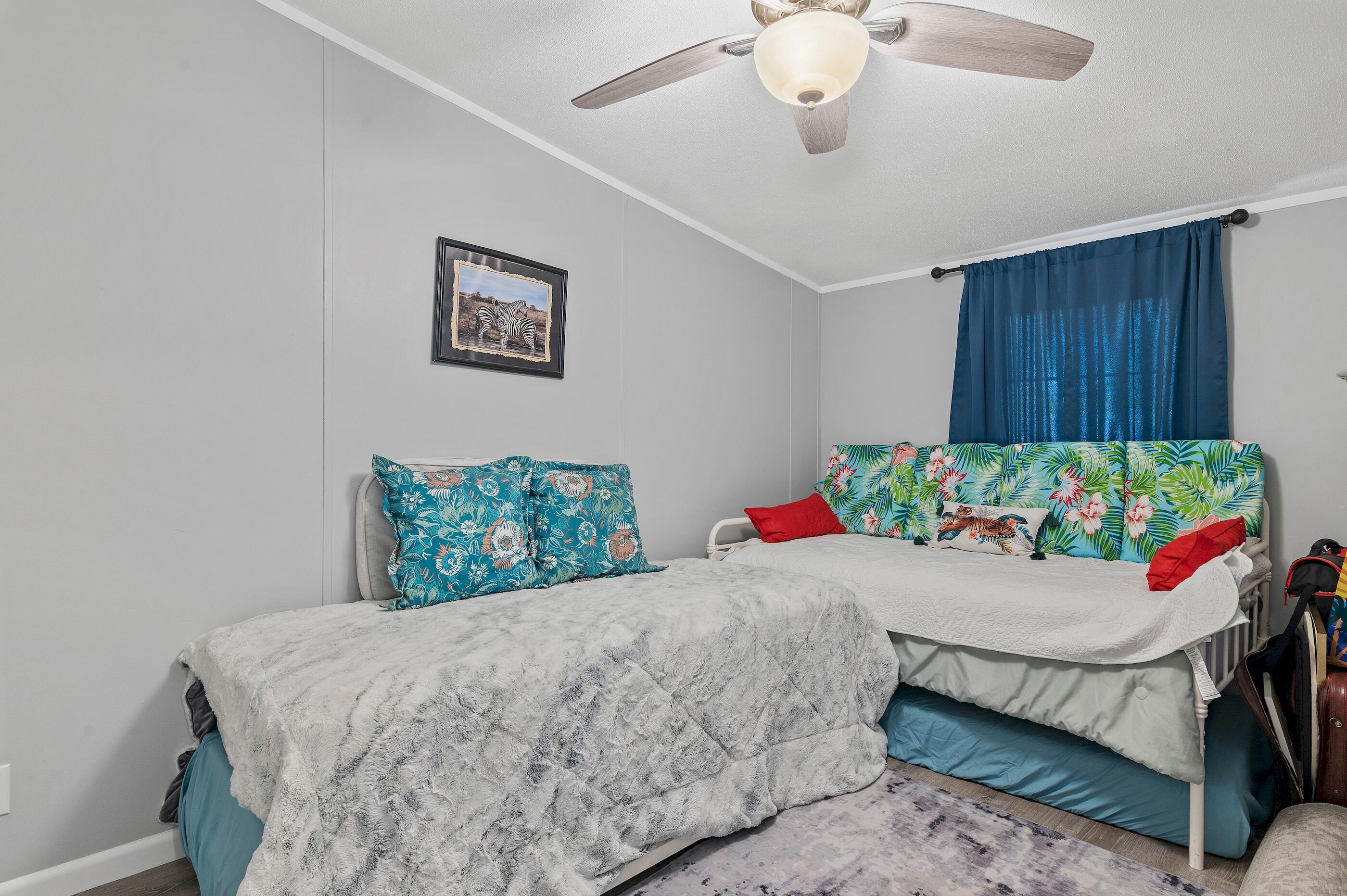 301 Edgewood Terrace Santa Rosa Beach, FL 32459 - Photo 24 of 34 a bedroom with a bed and a table in it