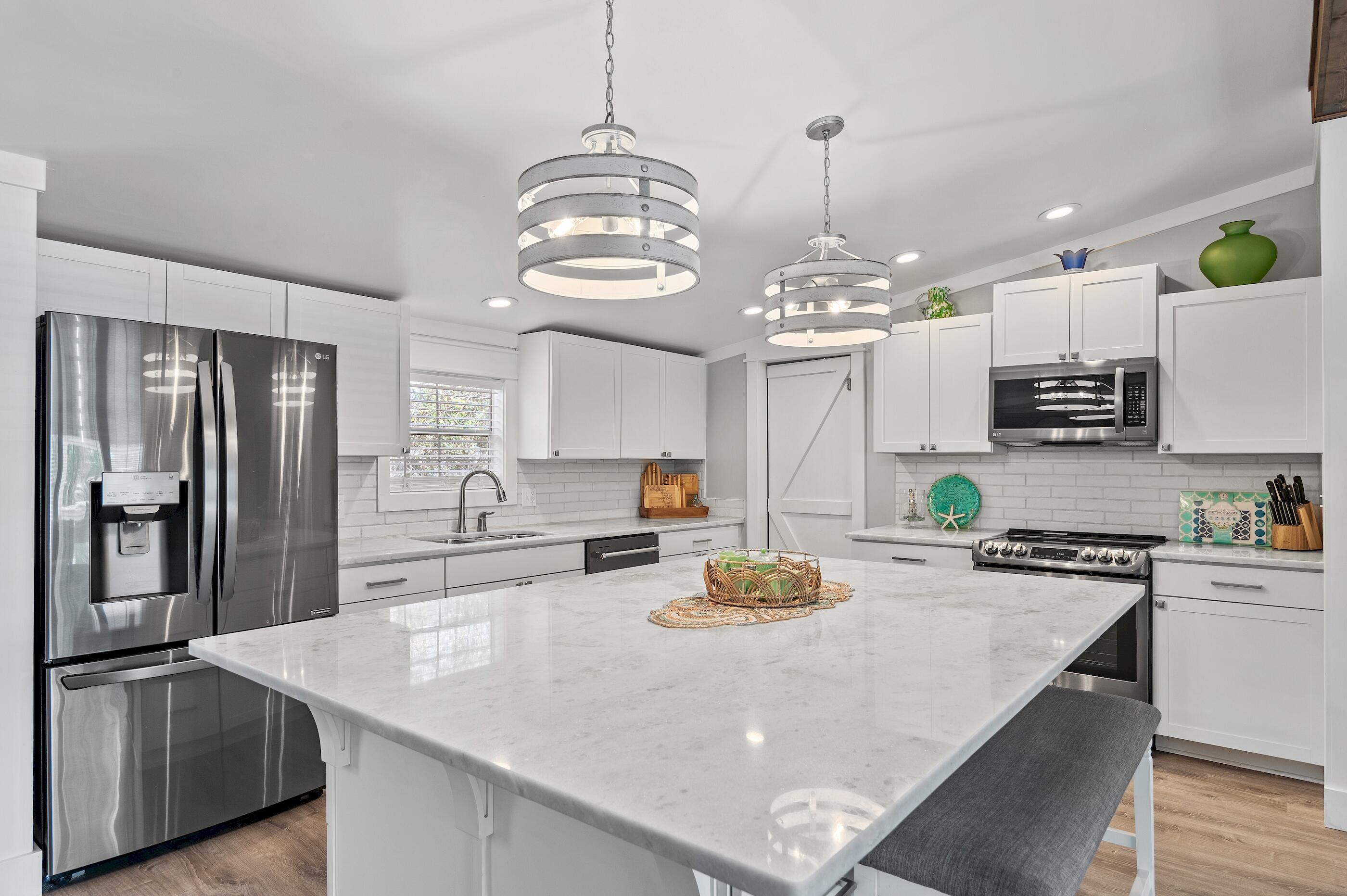 301 Edgewood Terrace Santa Rosa Beach, FL 32459 - Photo 3 of 34 a kitchen with sink cabinets and refrigerator