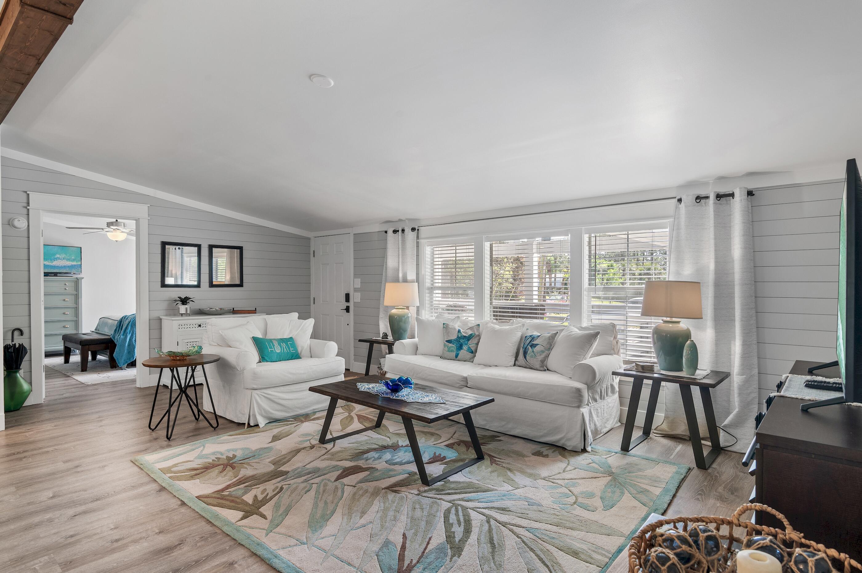 301 Edgewood Terrace Santa Rosa Beach, FL 32459 - Photo 6 of 34 a living room with furniture wooden floor and a large window