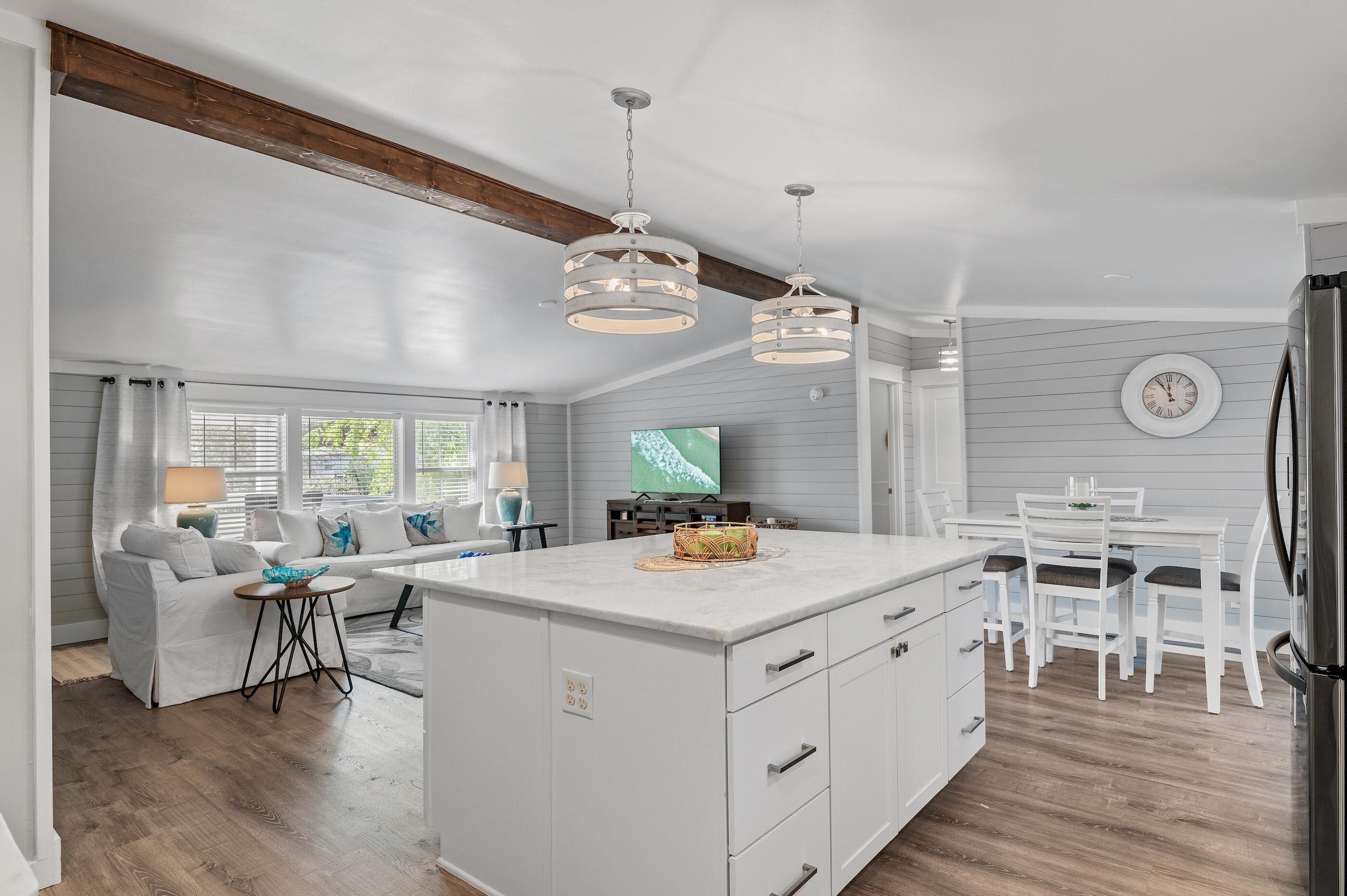 301 Edgewood Terrace Santa Rosa Beach, FL 32459 - Photo 8 of 34 a view of a dining room with furniture a chandelier and wooden floor