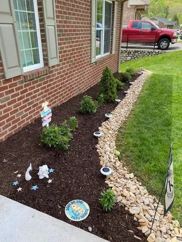 a backyard of a house with lots of green space and fountain