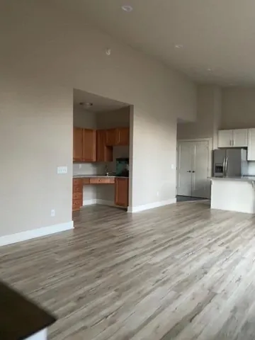 a view of a kitchen with wooden floor and a sink