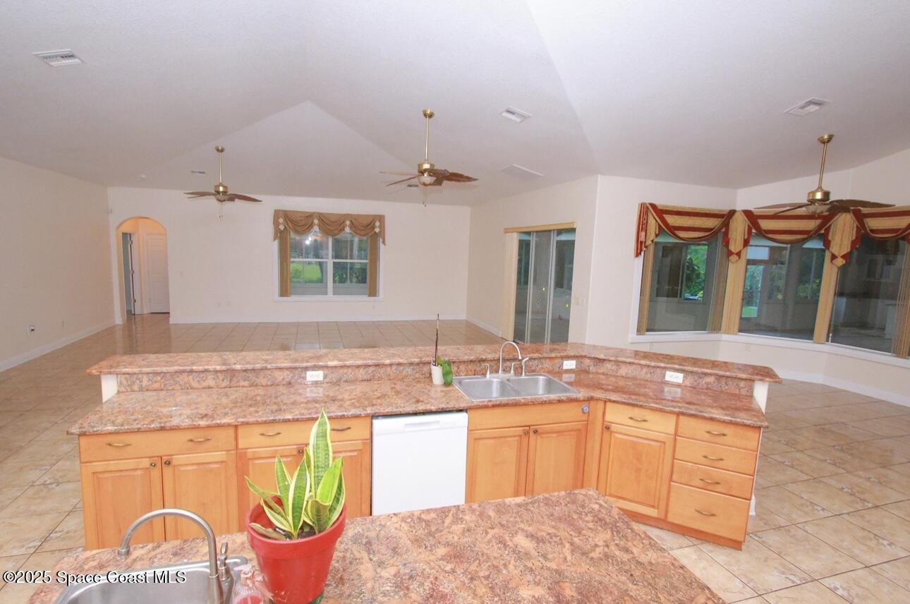 1857 Timbers W Boulevard Rockledge, FL 32955 - Photo 17 of 44 a bathroom with a granite countertop sink and a mirror