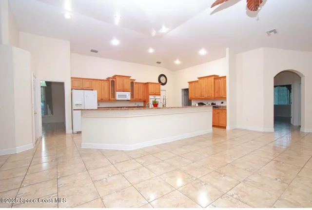 a large white kitchen with cabinets