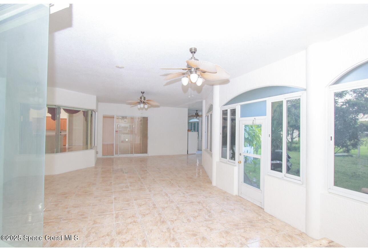1857 Timbers W Boulevard Rockledge, FL 32955 - Photo 27 of 44 a view of a room with a chandelier fan and windows