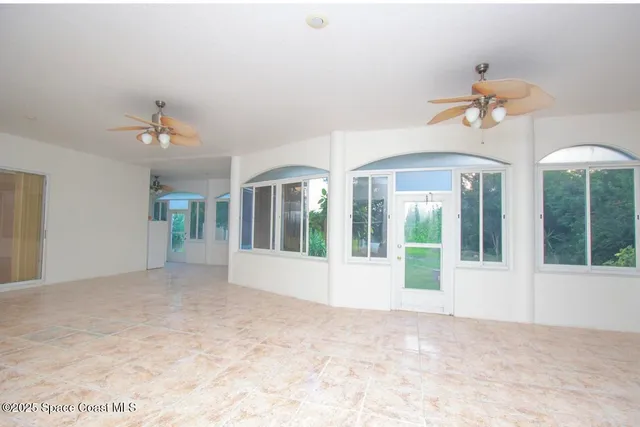a view of pool with hallway and chandelier
