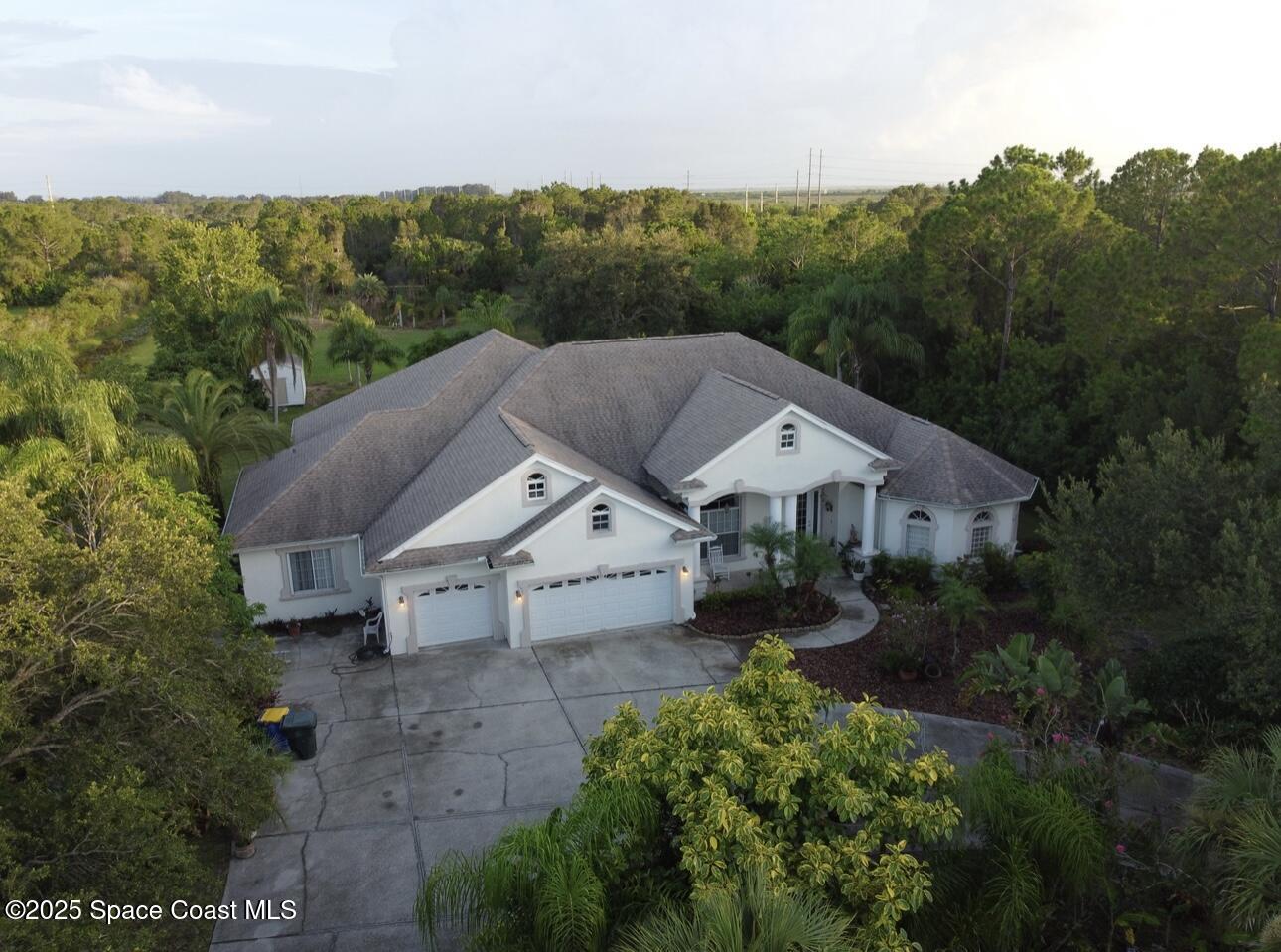 1857 Timbers W Boulevard Rockledge, FL 32955 - Photo 3 of 44 an aerial view of a house with mountain view
