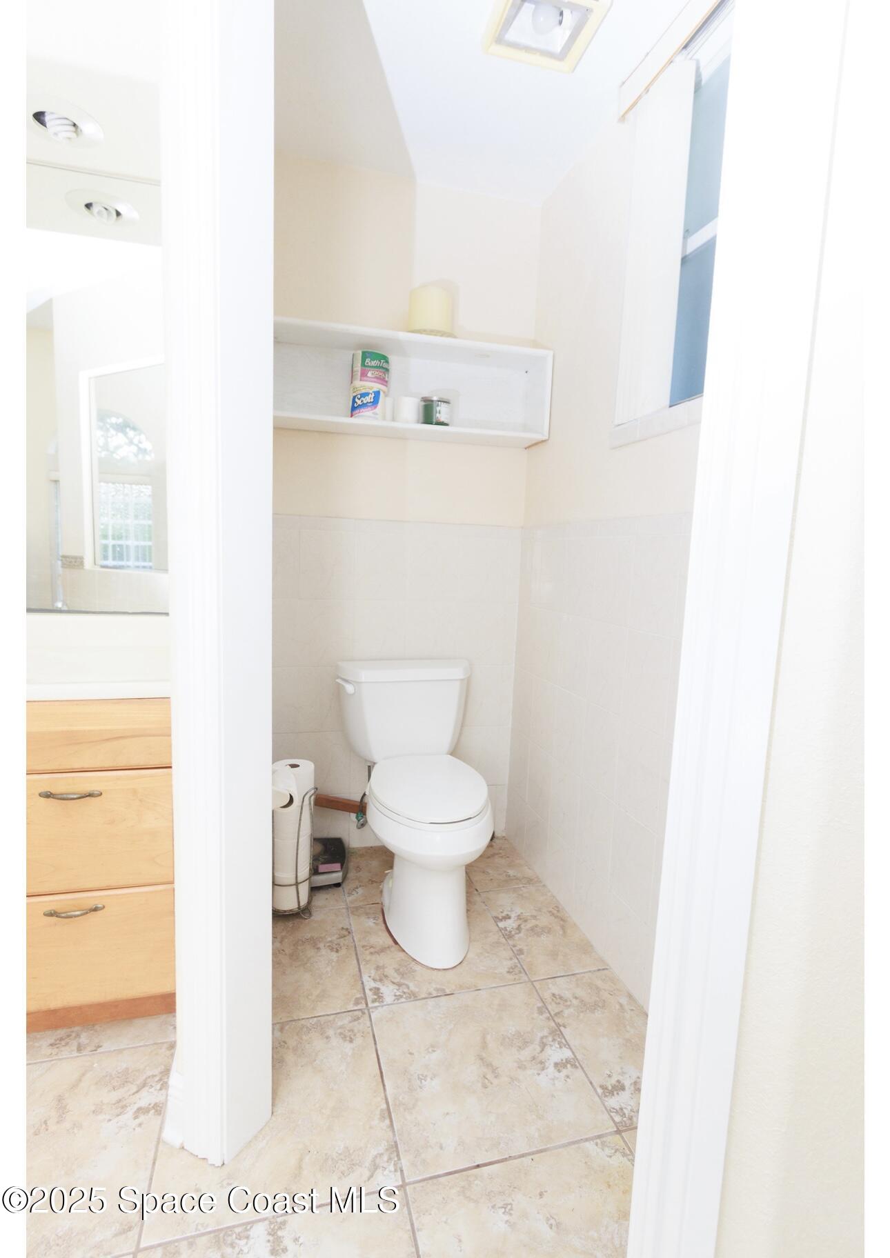 1857 Timbers W Boulevard Rockledge, FL 32955 - Photo 35 of 44 a bathroom with a toilet and a picture