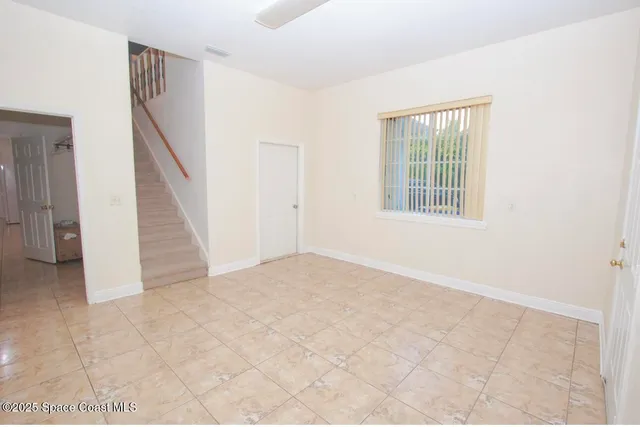 a view of an empty room with windows