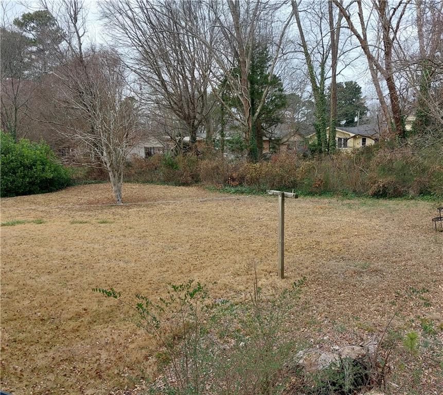 1803 Hasty Road Marietta, GA 30062 - Photo 16 of 23 a backyard of a house with lots of tall trees