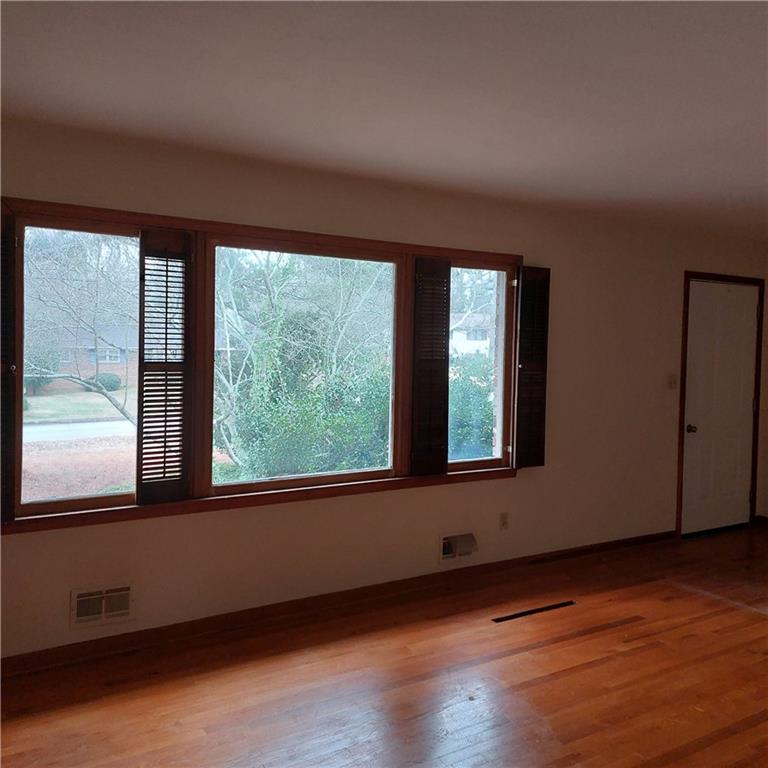 1803 Hasty Road Marietta, GA 30062 - Photo 6 of 23 a view of an empty room with wooden floor and a window