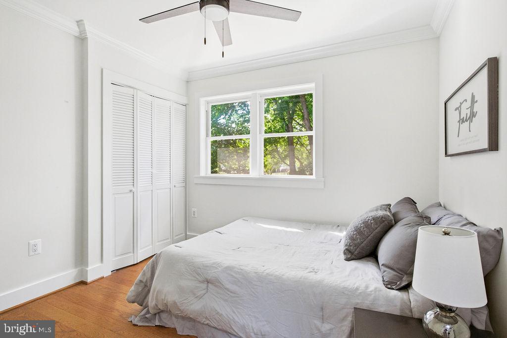 6620 Napoli Road Temple Hills, MD 20748 - Photo 13 of 38 a bedroom with a bed and wooden floor