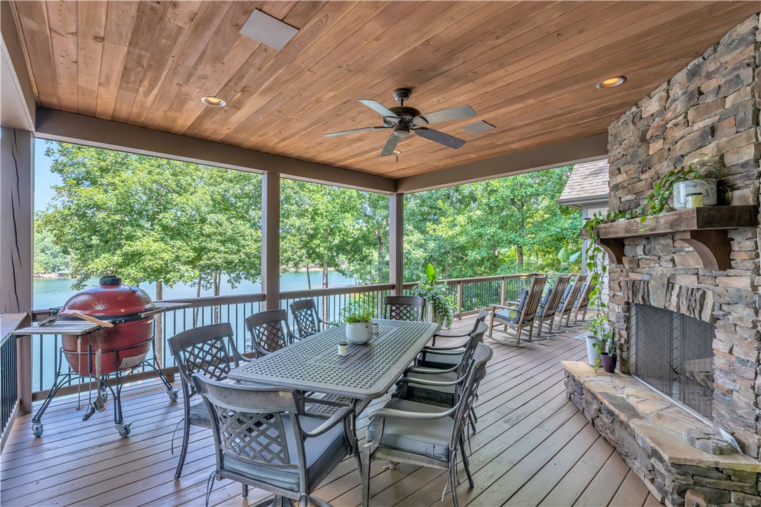 256 Talton Road Six Mile, SC 29682 - Photo 46 of 50 An inviting covered deck integrates a rugged stone fireplace with rich wood plank ceilings.