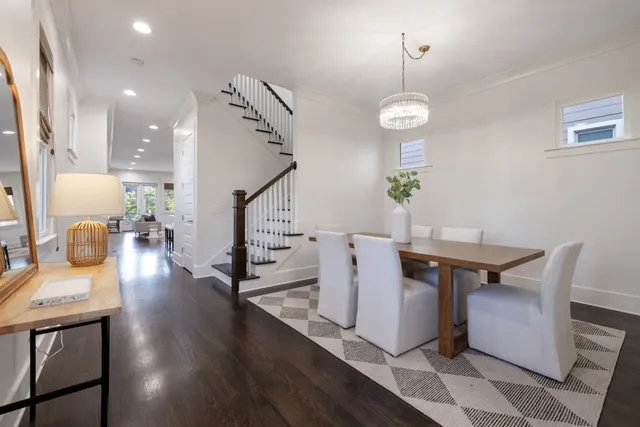 a dining room with furniture and wooden floor