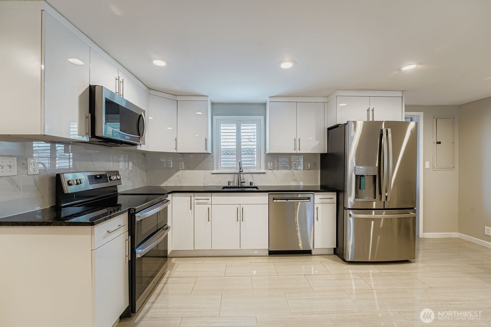 3533 Southeast 5th Street Renton, WA 98058 - Photo 13 of 25 a kitchen with stainless steel appliances granite countertop a refrigerator stove a sink and a microwave