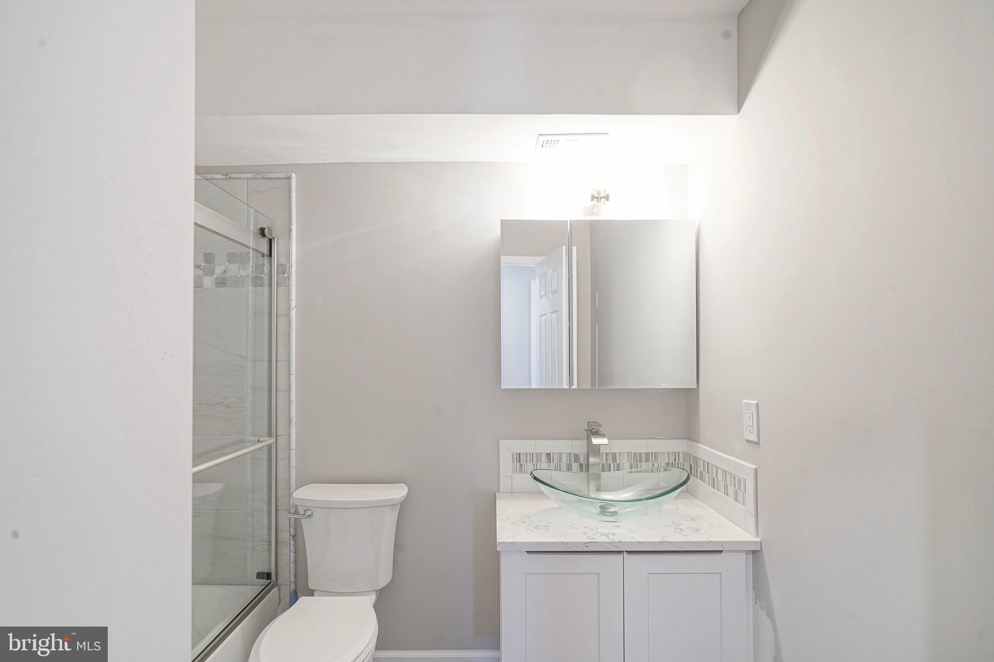 9 Samuel Adams Sewell, NJ 08080 - Photo 12 of 19 a bathroom with a granite countertop sink a toilet and a mirror
