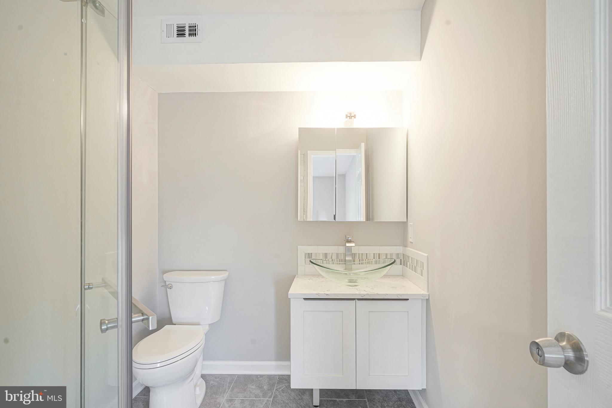 9 Samuel Adams Sewell, NJ 08080 - Photo 16 of 19 a bathroom with a granite countertop sink a toilet and a mirror