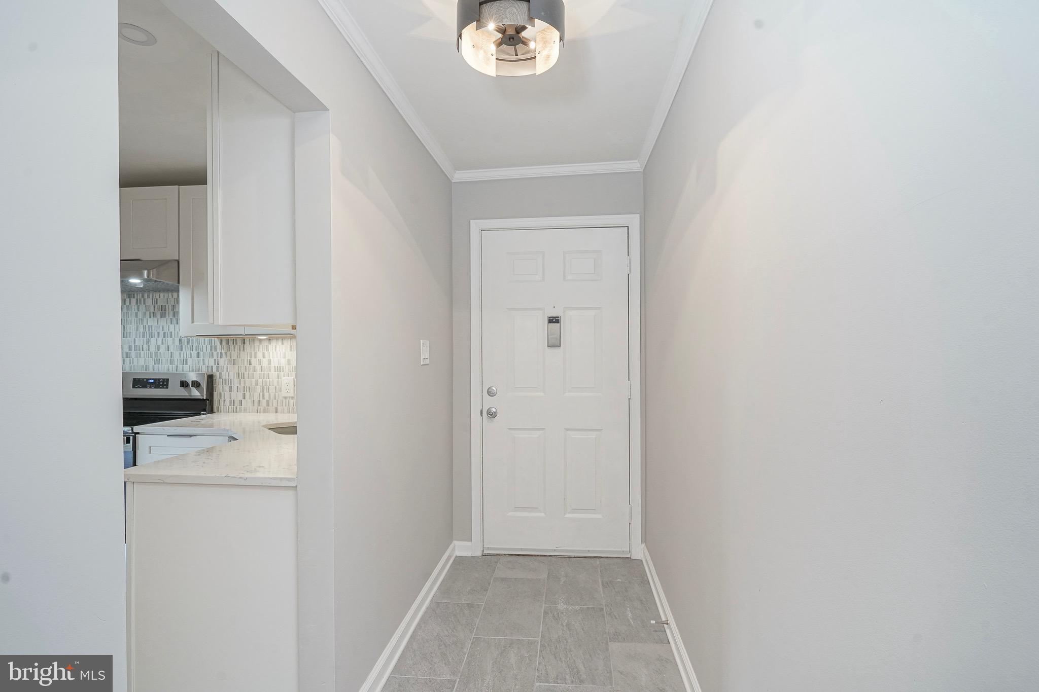 9 Samuel Adams Sewell, NJ 08080 - Photo 9 of 19 a view of washer and dryer with kitchen in the background