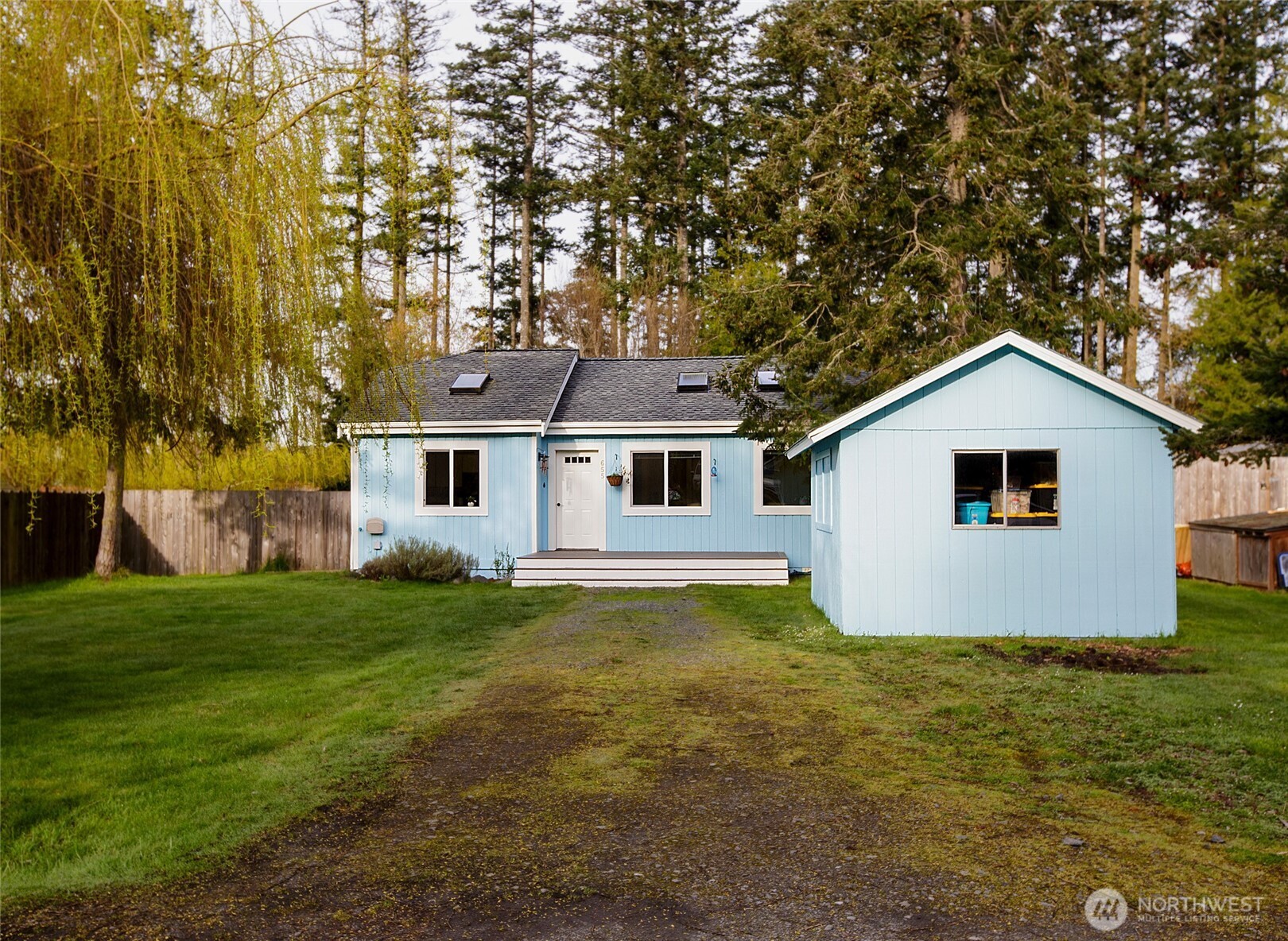 655 Hunt Street Friday Harbor, WA 98250 - Photo 17 of 26 a view of a yard in front of a house with large trees