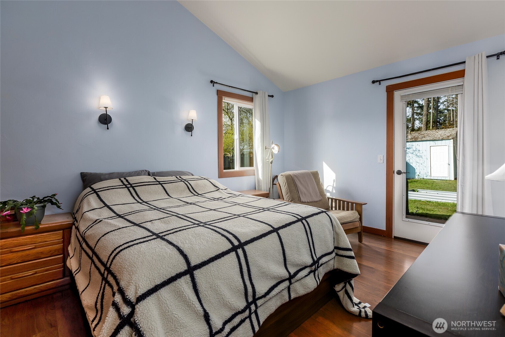 655 Hunt Street Friday Harbor, WA 98250 - Photo 9 of 26 a bedroom with a bed and wooden floor