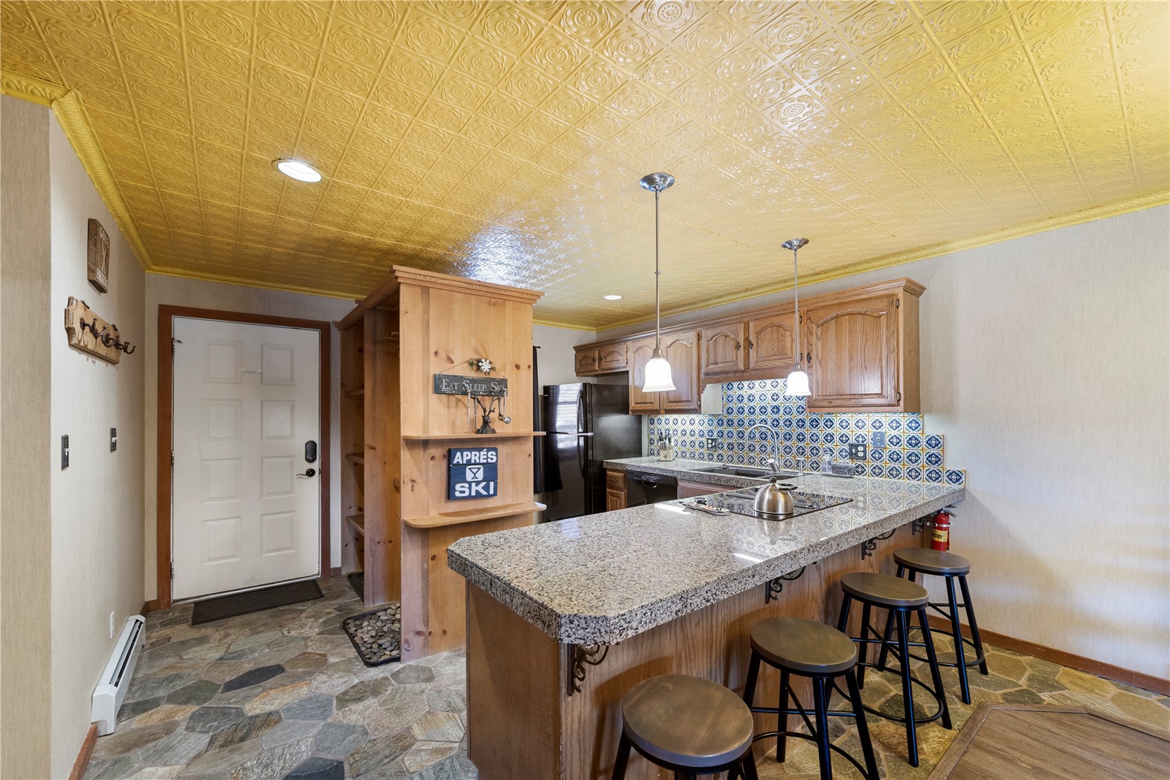 9490 Ryan Gulch Road, Unit 94202 Silverthorne, CO 80498 - Photo 11 of 50 a kitchen with a table and chairs in it