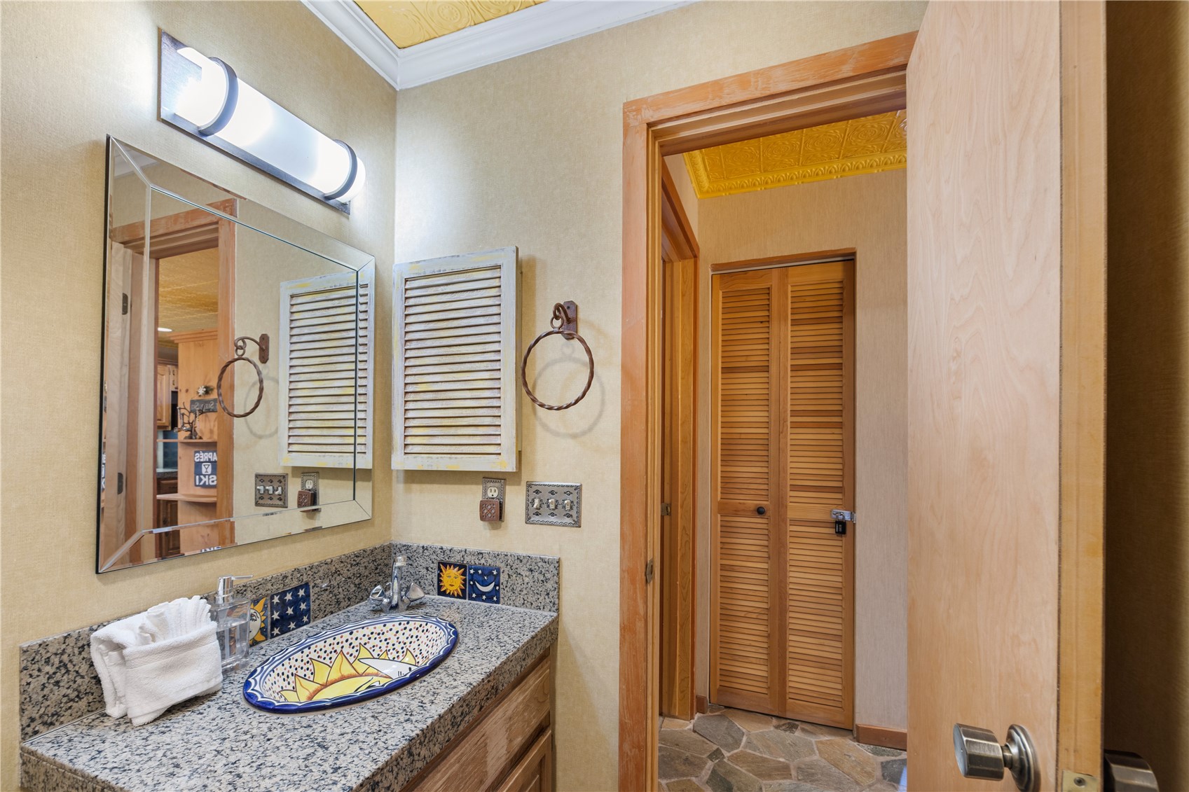 9490 Ryan Gulch Road, Unit 94202 Silverthorne, CO 80498 - Photo 16 of 50 a bathroom with a granite countertop sink and a mirror
