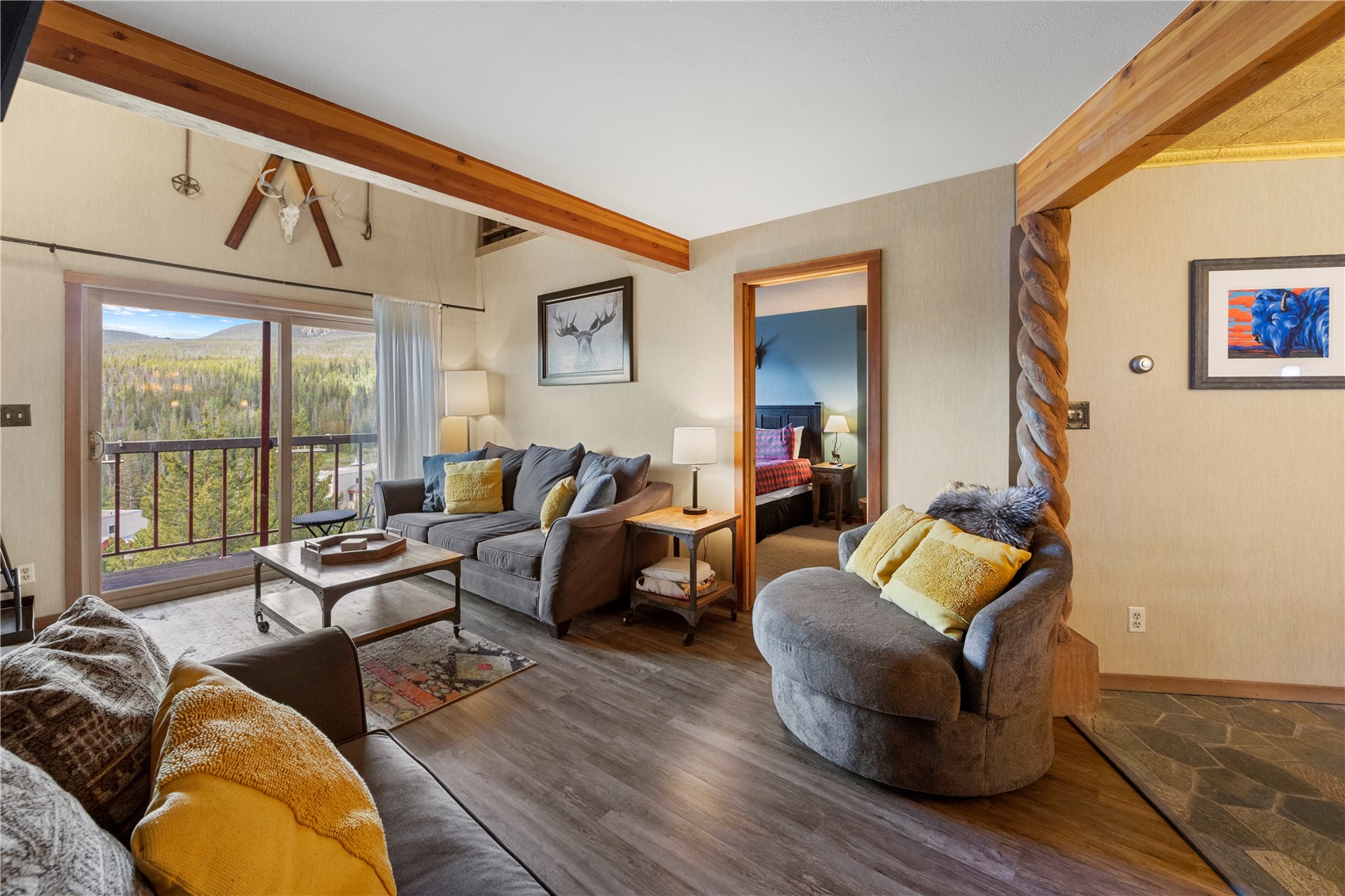 9490 Ryan Gulch Road, Unit 94202 Silverthorne, CO 80498 - Photo 18 of 50 a living room with furniture and a floor to ceiling window