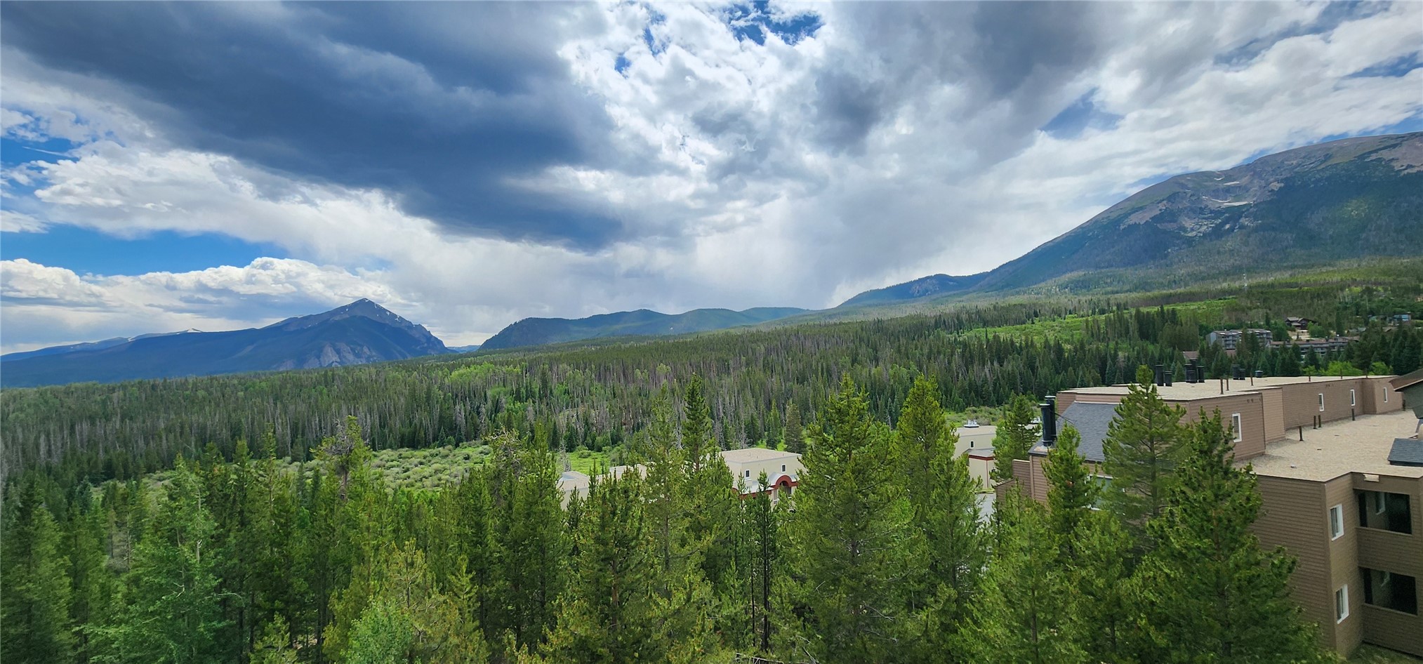 9490 Ryan Gulch Road, Unit 94202 Silverthorne, CO 80498 - Photo 2 of 50 a view of a lake with a yard