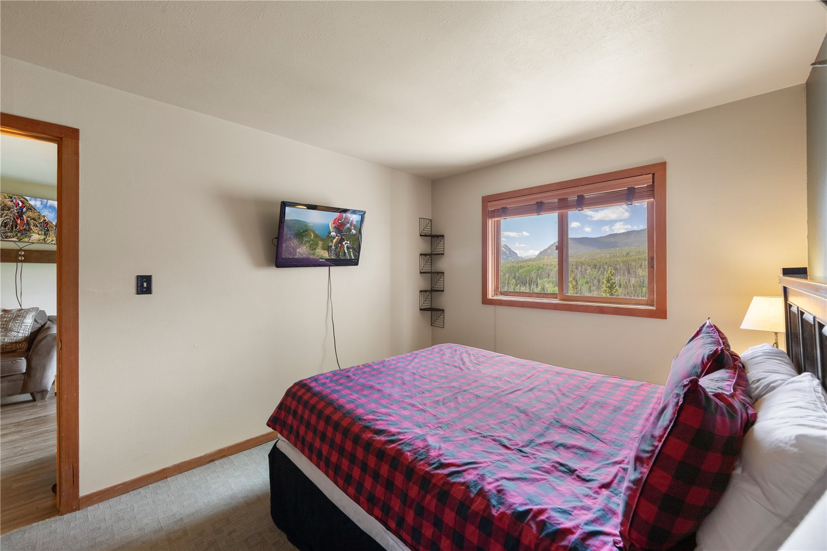 9490 Ryan Gulch Road, Unit 94202 Silverthorne, CO 80498 - Photo 21 of 50 a bed sitting in a bedroom next to a window