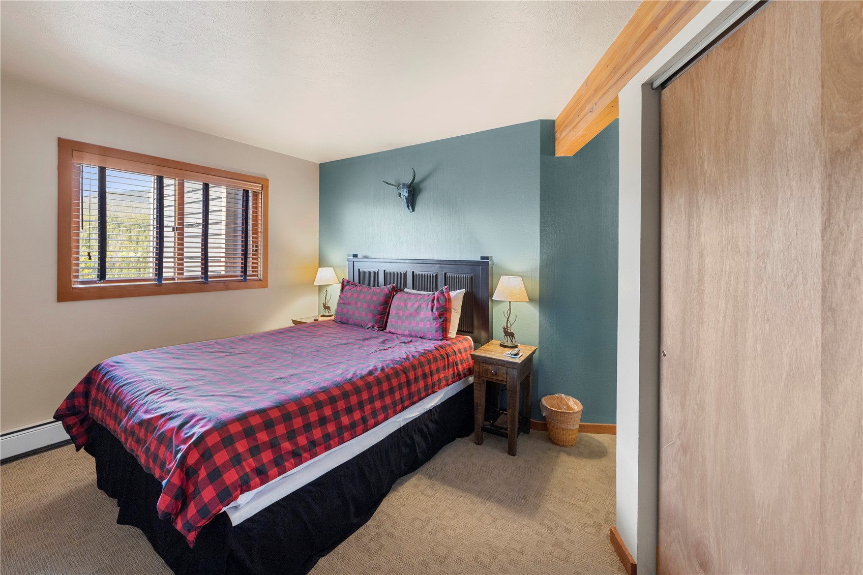 9490 Ryan Gulch Road, Unit 94202 Silverthorne, CO 80498 - Photo 22 of 50 a bedroom with a bed and window