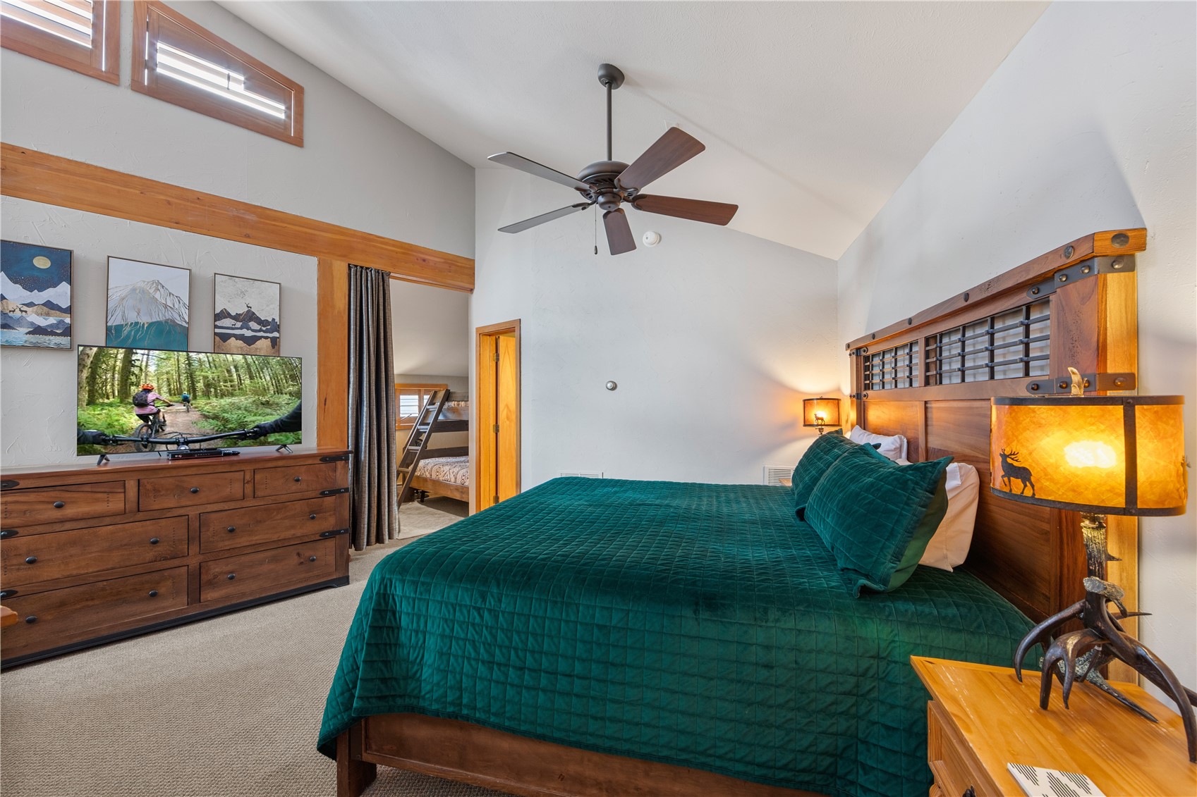 9490 Ryan Gulch Road, Unit 94202 Silverthorne, CO 80498 - Photo 29 of 50 a bedroom with a bed and a mirror on the dresser