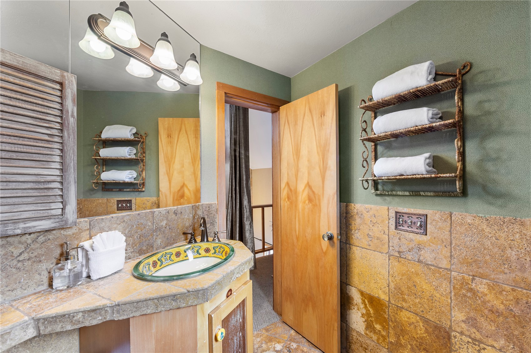 9490 Ryan Gulch Road, Unit 94202 Silverthorne, CO 80498 - Photo 30 of 50 a bathroom with a granite countertop sink and a mirror