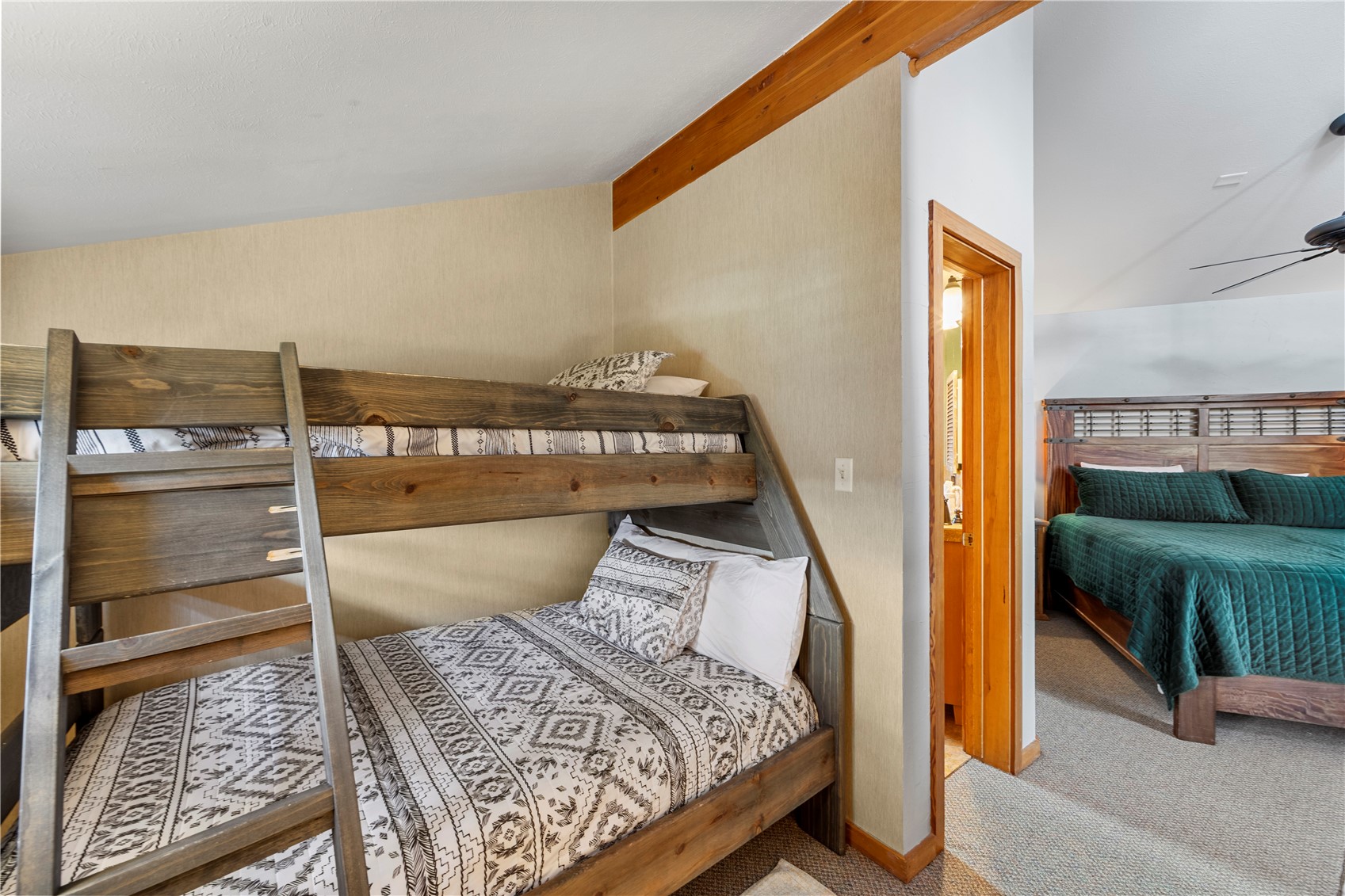 9490 Ryan Gulch Road, Unit 94202 Silverthorne, CO 80498 - Photo 32 of 50 a bedroom with a bed and balcony view