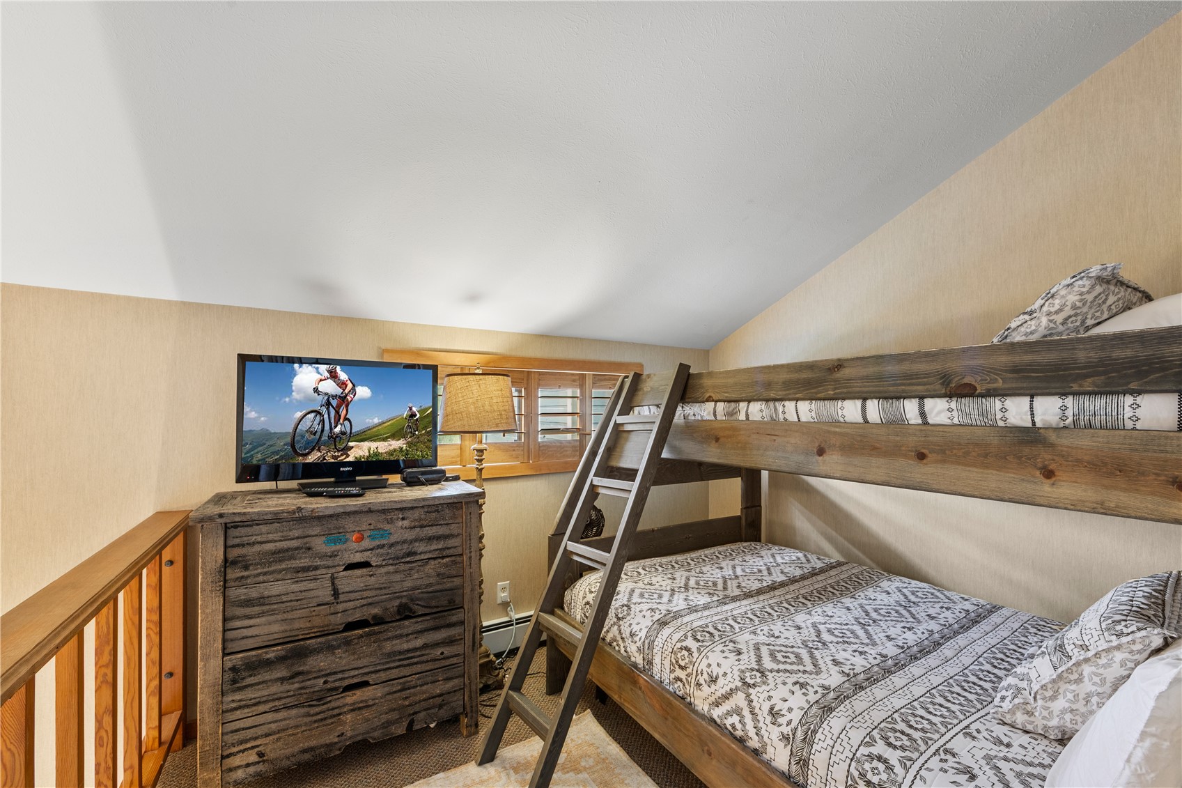 9490 Ryan Gulch Road, Unit 94202 Silverthorne, CO 80498 - Photo 33 of 50 a living room with couch and a flat screen tv