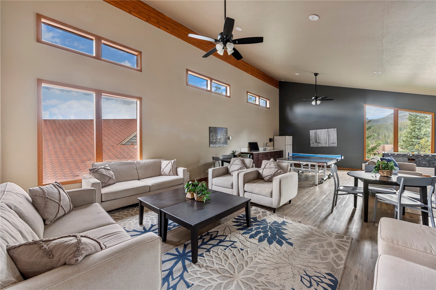 9490 Ryan Gulch Road, Unit 94202 Silverthorne, CO 80498 - Photo 45 of 50 a living room with furniture a table and a large window