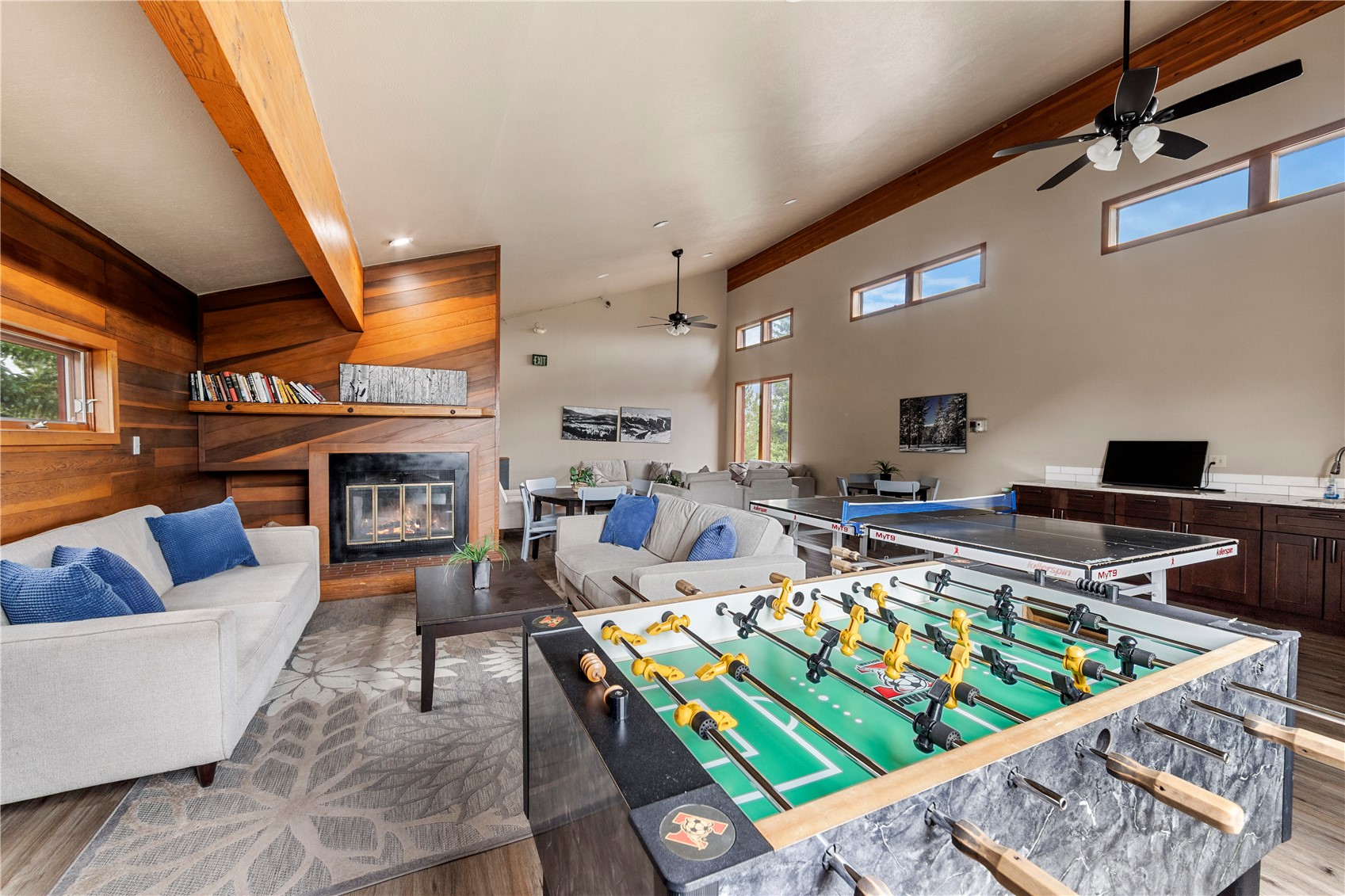 9490 Ryan Gulch Road, Unit 94202 Silverthorne, CO 80498 - Photo 46 of 50 a living room with furniture fireplace and a table