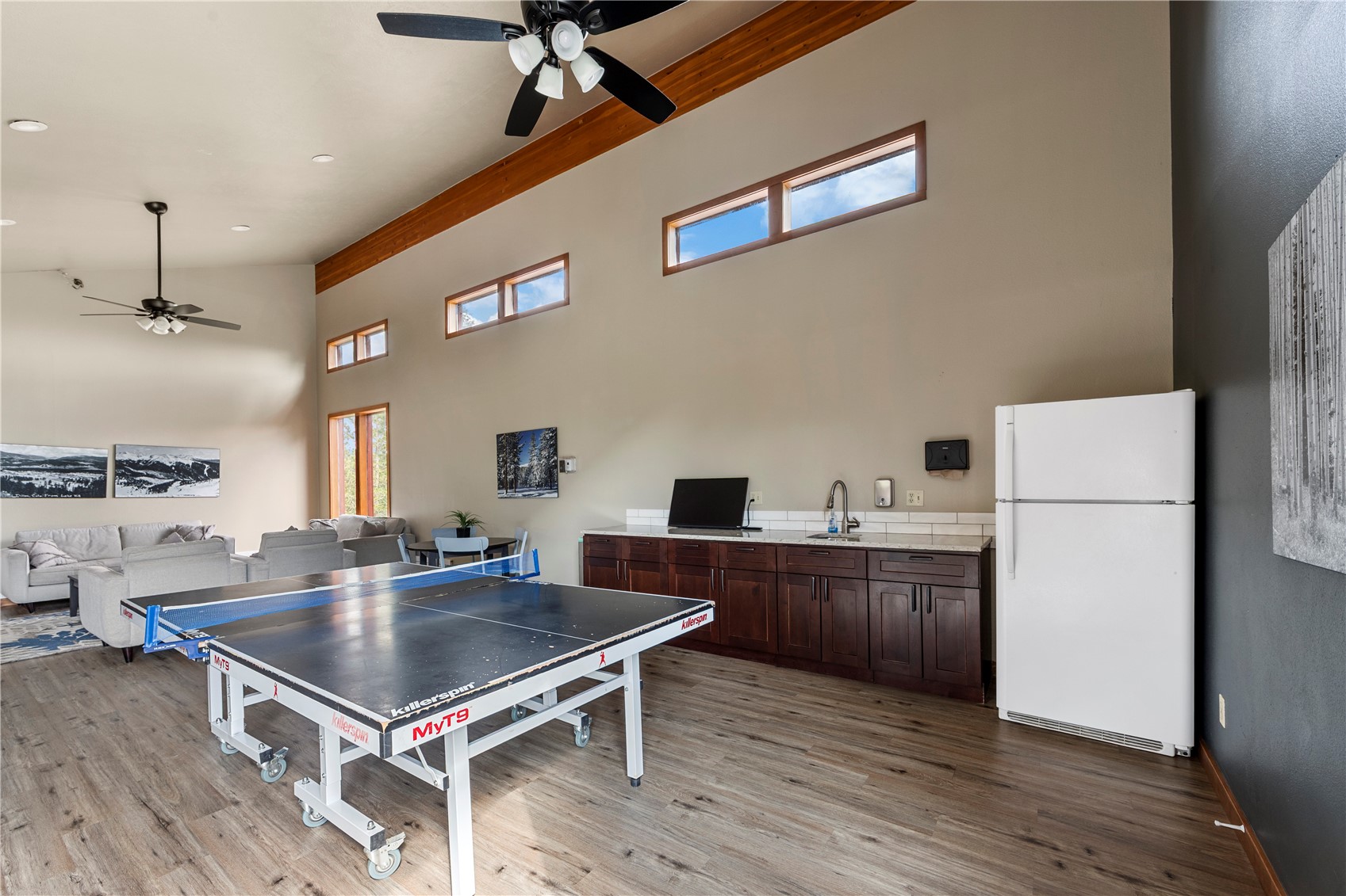9490 Ryan Gulch Road, Unit 94202 Silverthorne, CO 80498 - Photo 47 of 50 a kitchen with kitchen island a wooden floor and a refrigerator