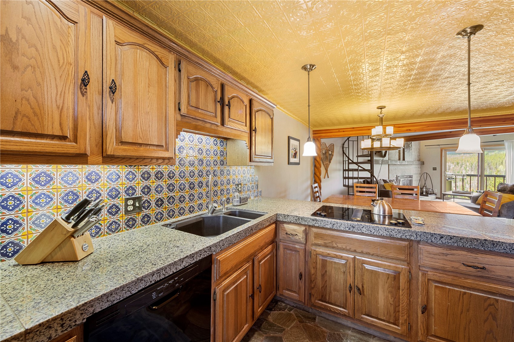 9490 Ryan Gulch Road, Unit 94202 Silverthorne, CO 80498 - Photo 5 of 50 a kitchen with stainless steel appliances granite countertop a sink a stove and a wooden cabinets
