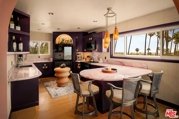 a dining room with furniture a chandelier and window
