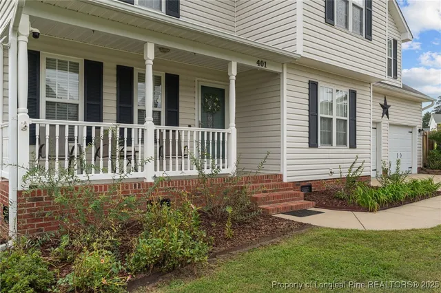 a view of a house with backyard and porch