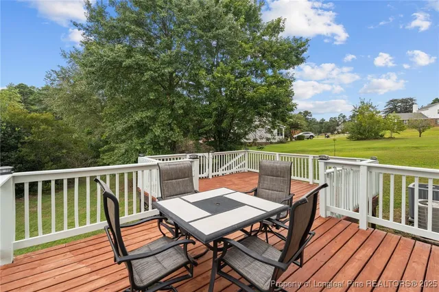 a view of balcony with wooden floor and fence