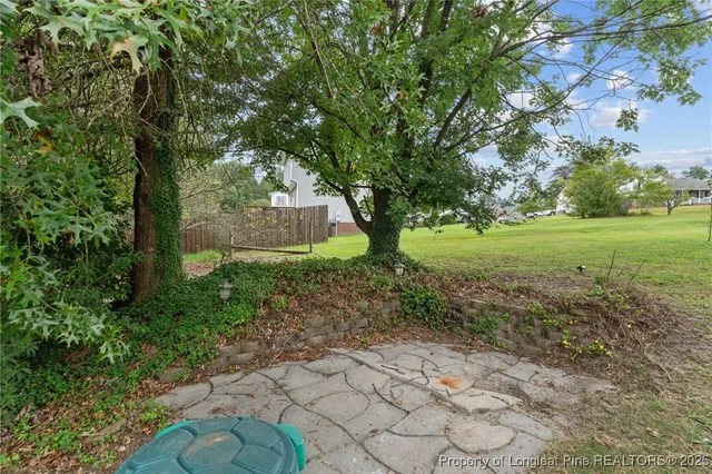 a view of a house with backyard and sitting area