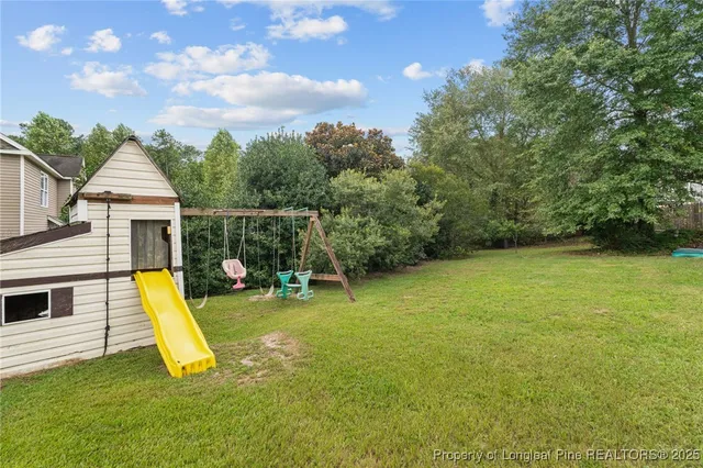 a view of a house with a backyard