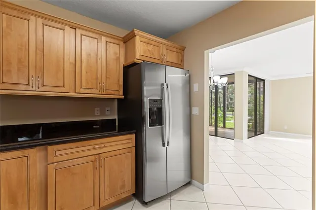 a kitchen with stainless steel appliances granite countertop a refrigerator and a sink