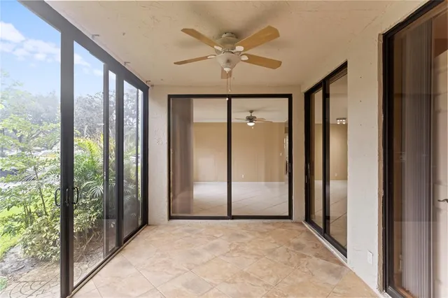 a view of a livingroom with a ceiling fan and window